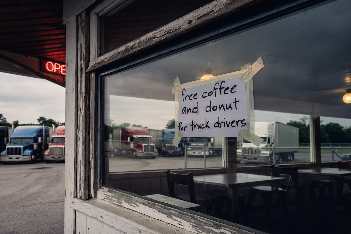 a truck stop offering free coffee and donut for truck driver appreciation week.