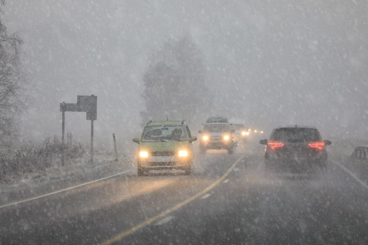 Cars driving in reduced visibility during winter trucking