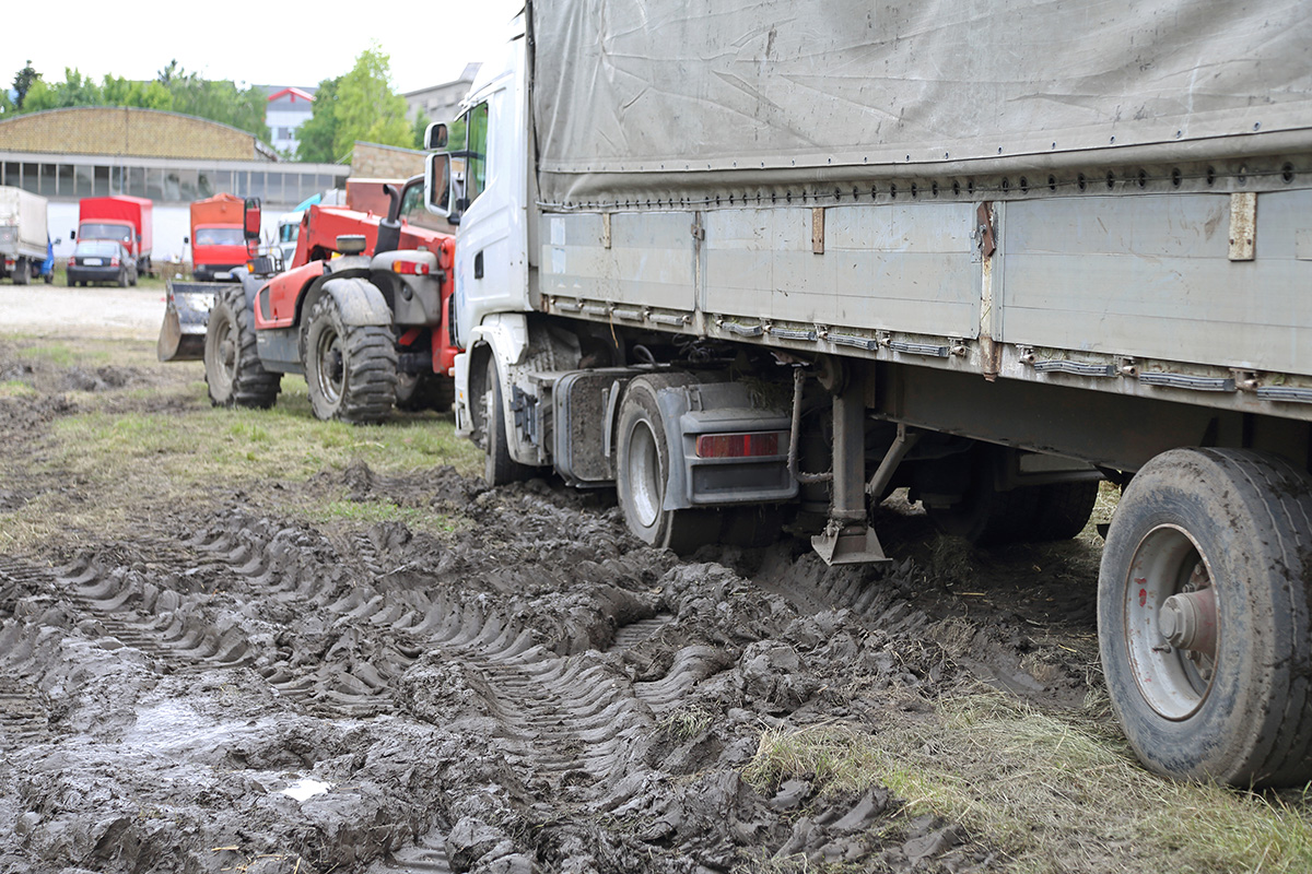 Truck with wheel stuck in the mud.