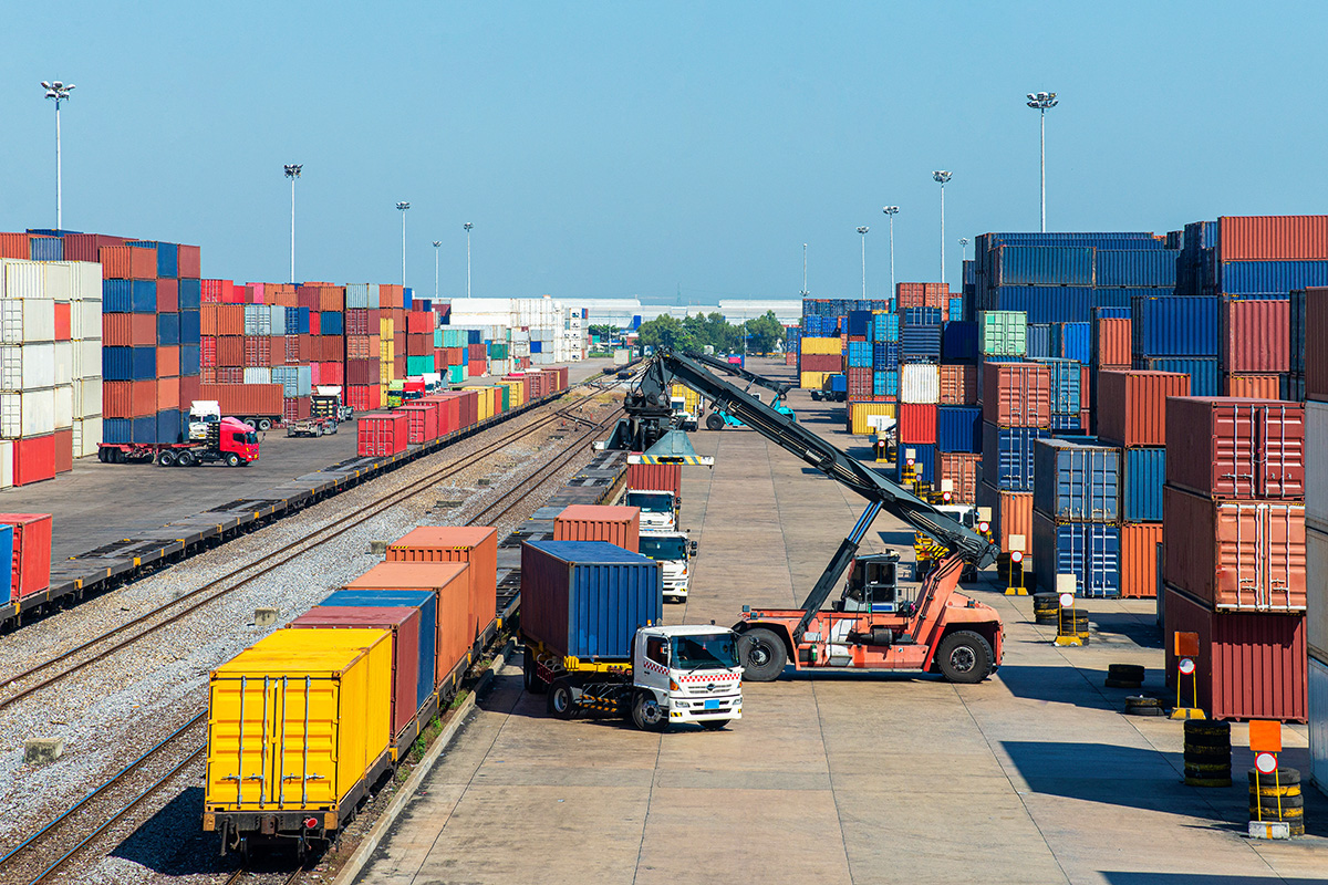A trucker being loaded up at a rail yard.